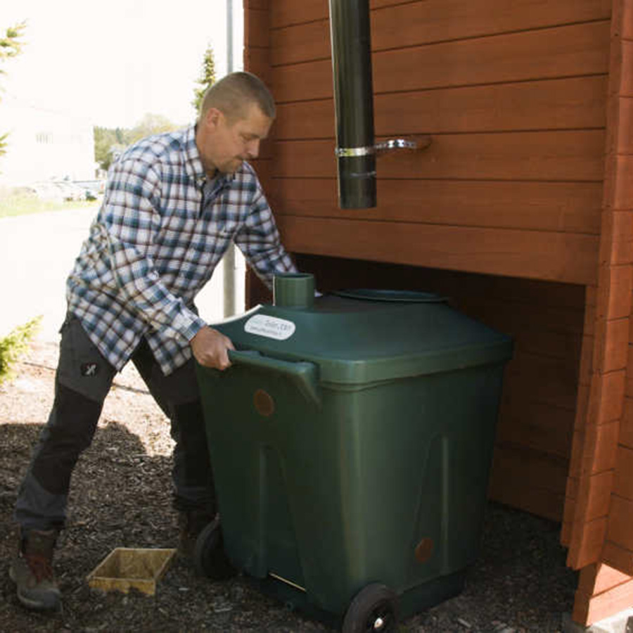 positioning the green toilet underneath the outhouse seat