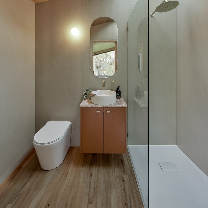 waterless toilet pedestal inside a bathroom tiny house