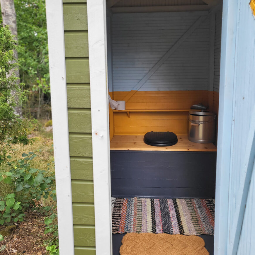 hinged thermal seat in an outhouse