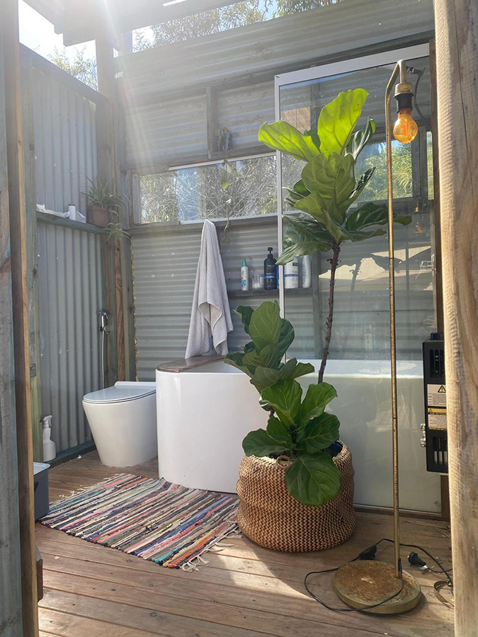 outdoor bathroom next to tiny house 2