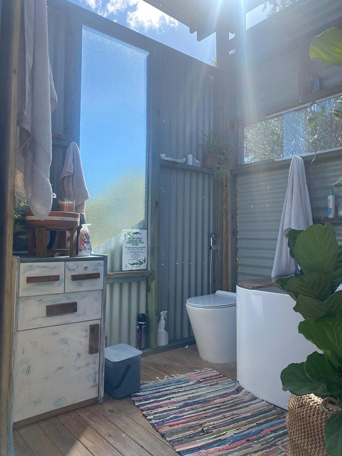 outdoor bathroom next to tiny house 3